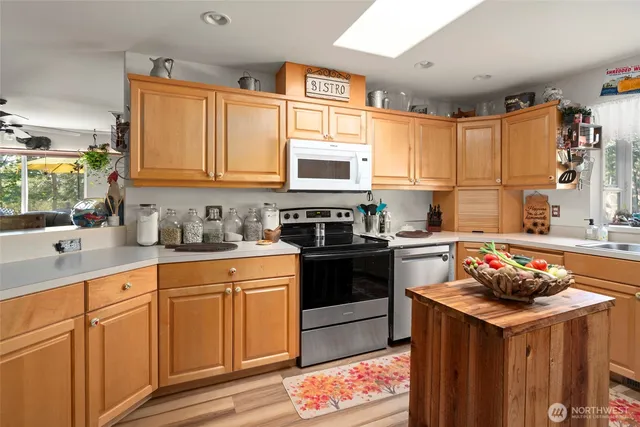 a kitchen with stainless steel appliances a refrigerator sink and cabinets