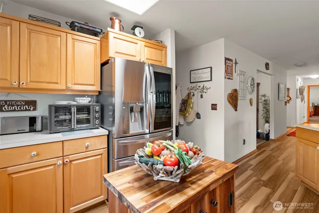 a kitchen with stainless steel appliances kitchen island granite countertop a sink stove and cabinets
