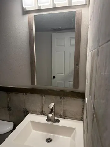 a bathroom with a sink and cabinets