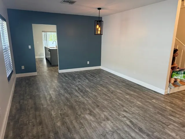a view of a hallway with wooden floor