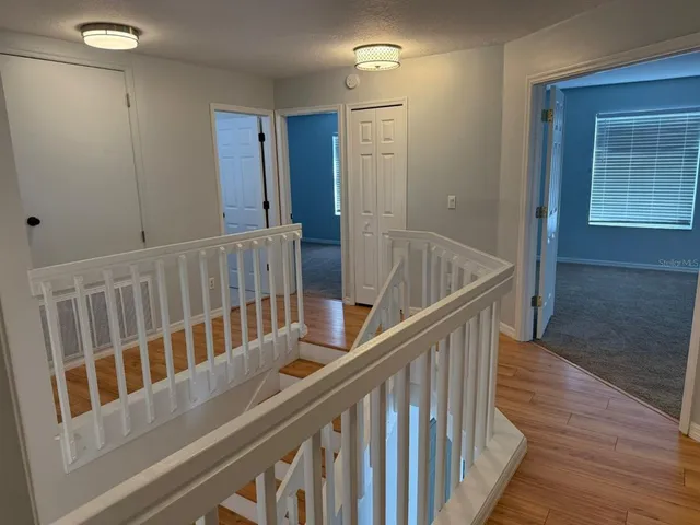 a view of wooden staircase with wooden floor and stairs