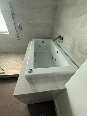a bathroom with a bath tub