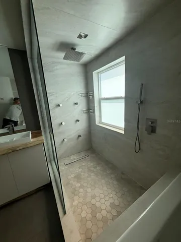 a bathroom with a bathtub and a window