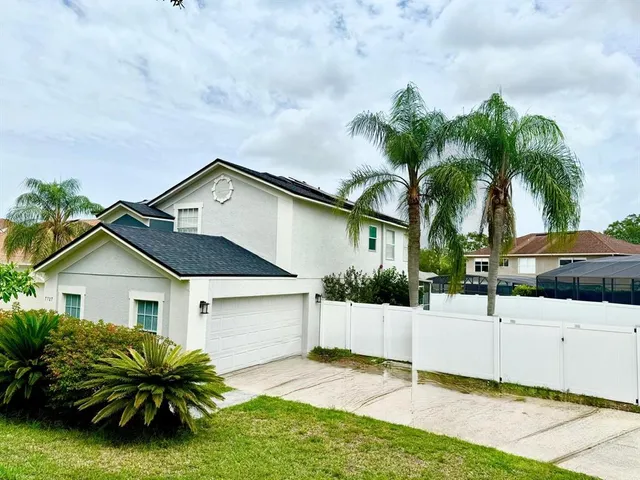 a front view of house with yard and green space