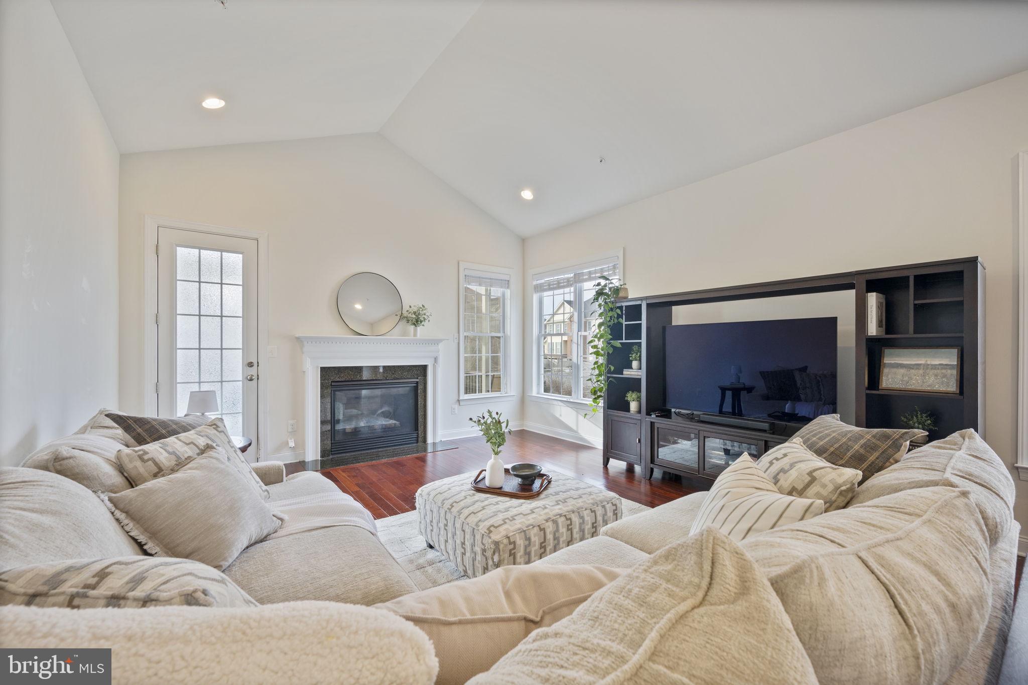 8414 Maple Brook Lane Severn, MD 21144 - Photo 20 of 78 a living room with furniture a fireplace and a flat screen tv