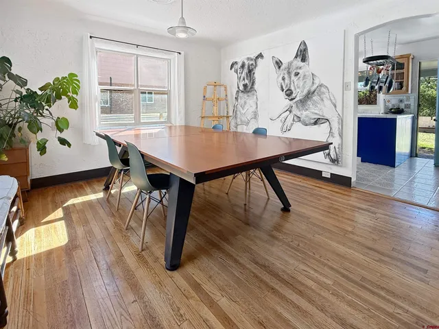 a view of a dining room with furniture and wooden floor