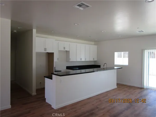 a kitchen with stainless steel appliances a refrigerator sink and microwave