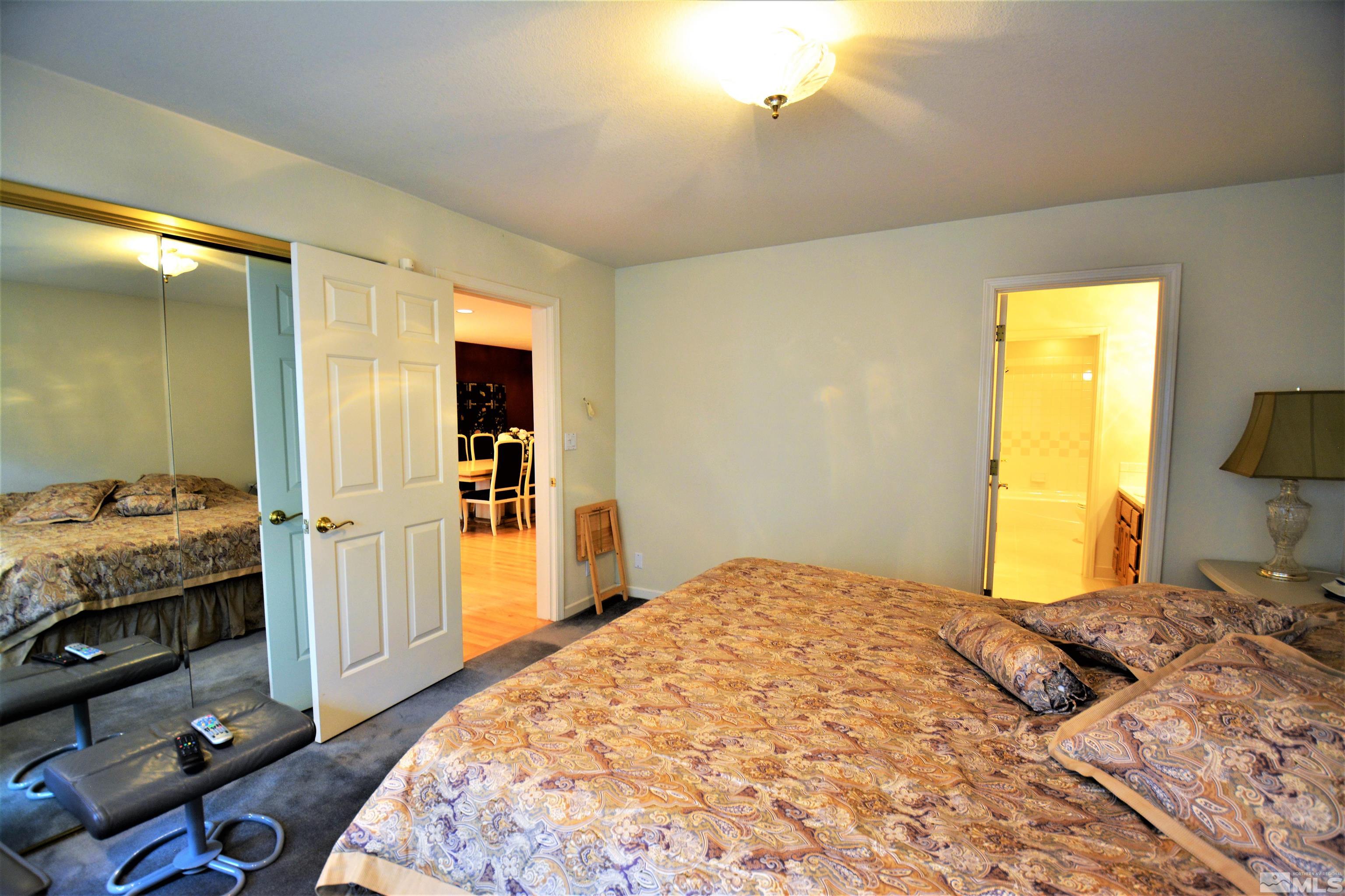 545 Skyline Boulevard Reno, NV 89509 - Photo 16 of 39 a bedroom with a bed and a flat tv screen on dresser
