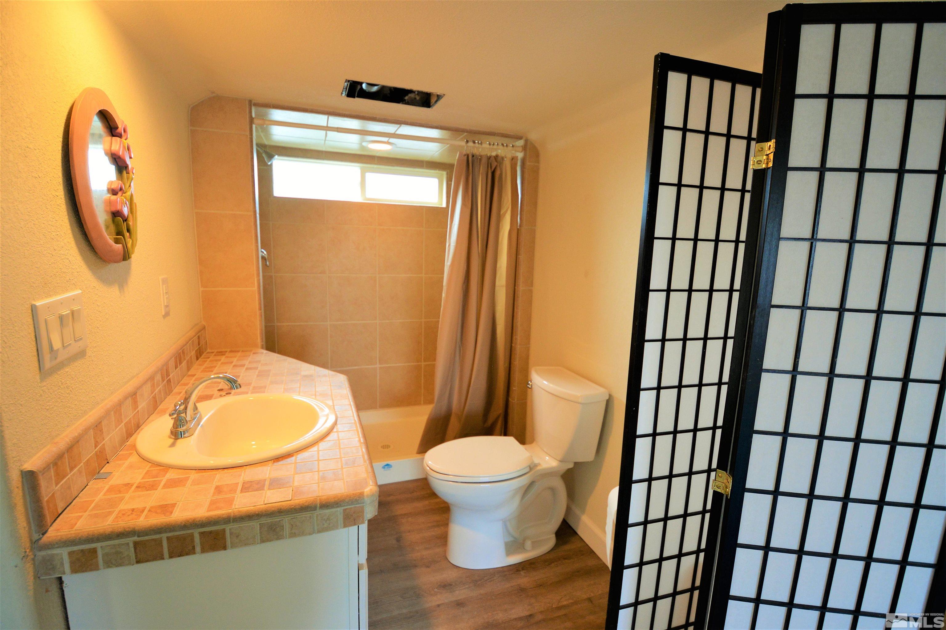 545 Skyline Boulevard Reno, NV 89509 - Photo 38 of 39 a bathroom with a sink toilet and a mirror