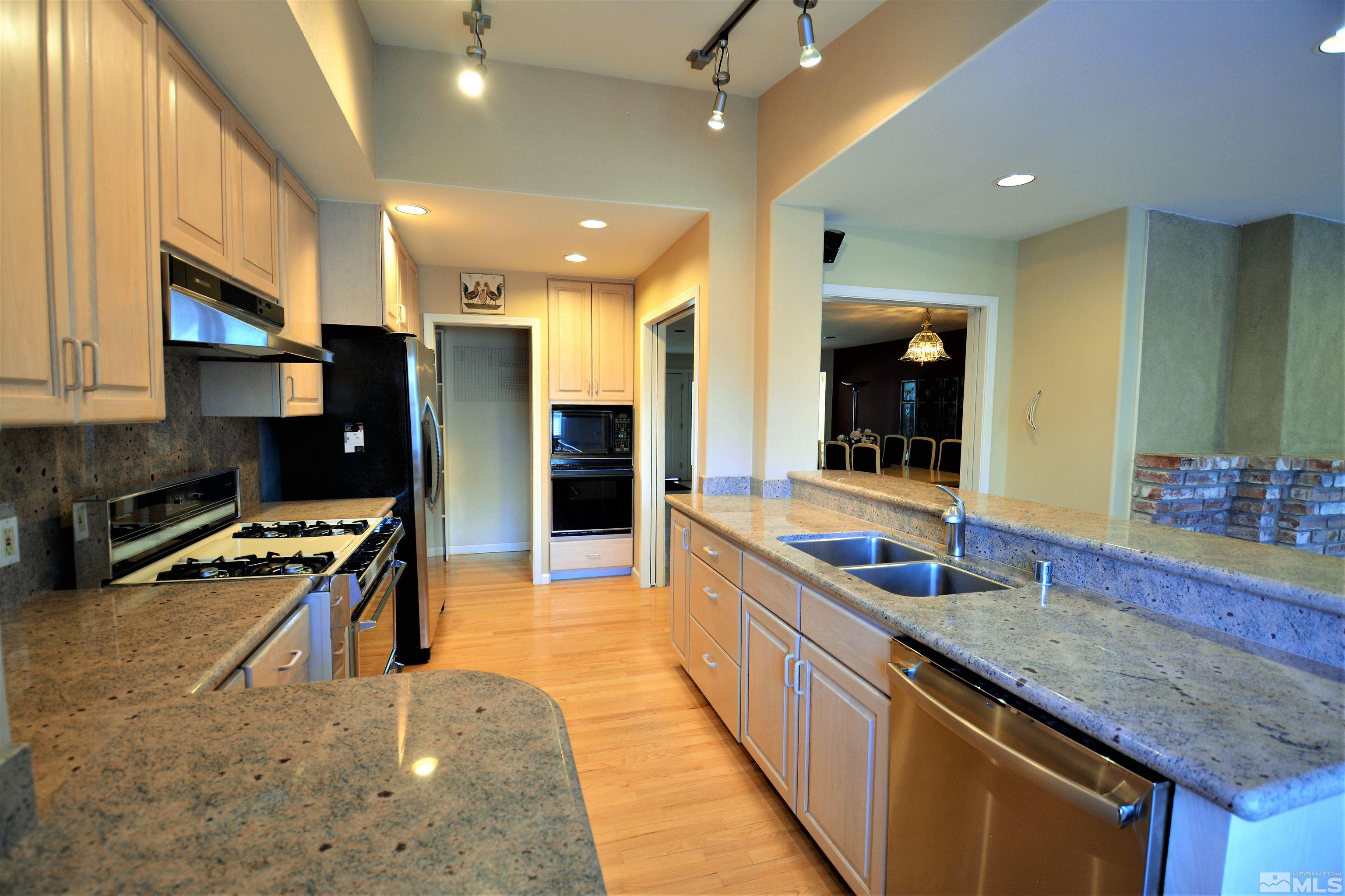 545 Skyline Boulevard Reno, NV 89509 - Photo 7 of 39 a large kitchen with stainless steel appliances a large counter top a stove and a sink