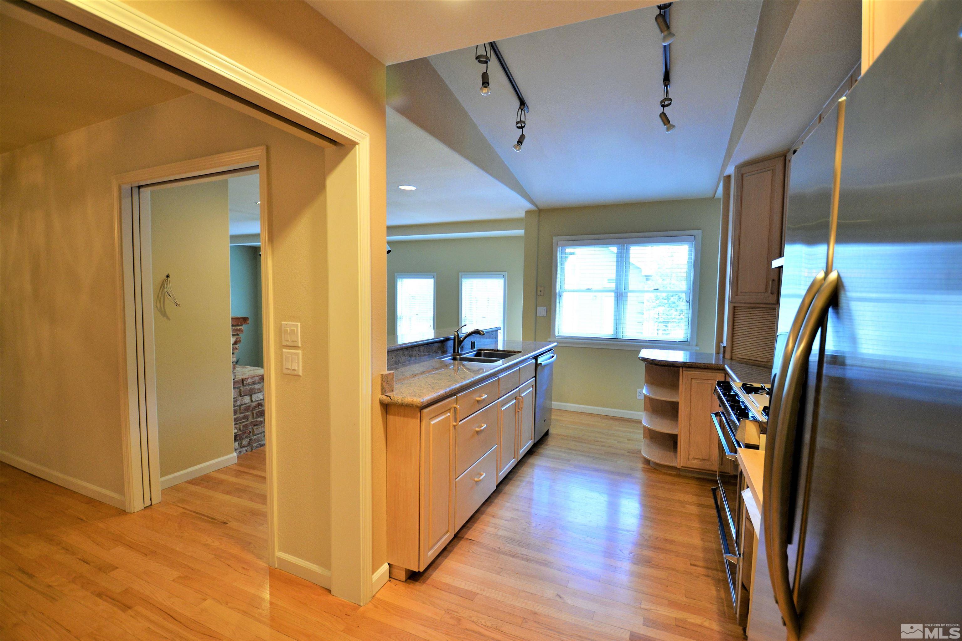 545 Skyline Boulevard Reno, NV 89509 - Photo 9 of 39 a large kitchen with a counter space wooden floor and a sink