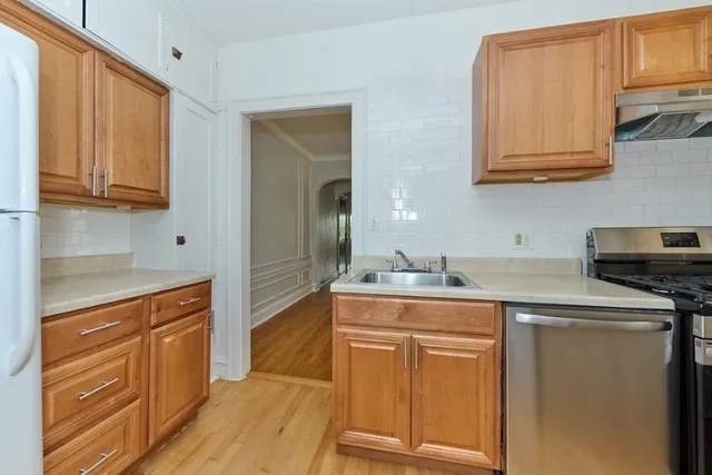 a kitchen with stainless steel appliances granite countertop a sink stove and cabinets