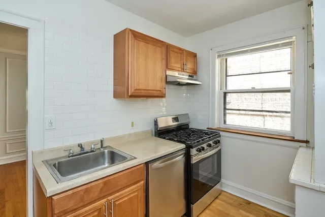 a kitchen that has a sink and a stove top oven