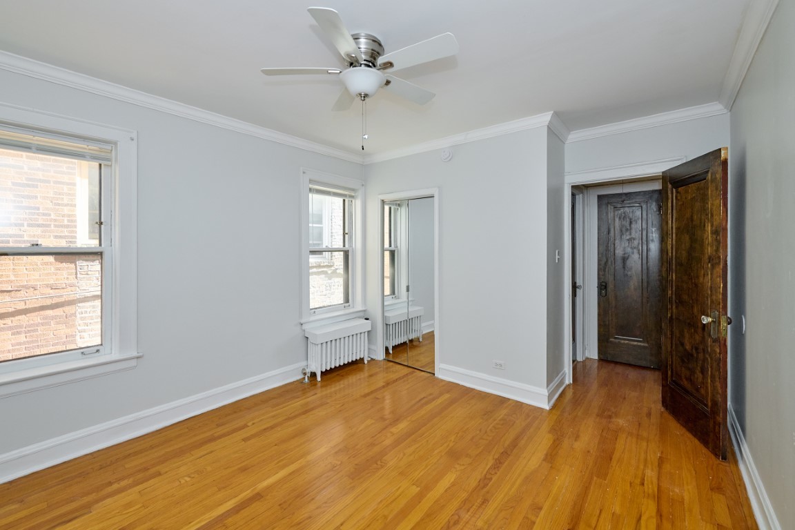 1112 Grove Street, Unit 2B Evanston, IL 60201 - Photo 14 of 21 a view of empty room with wooden floor and fan