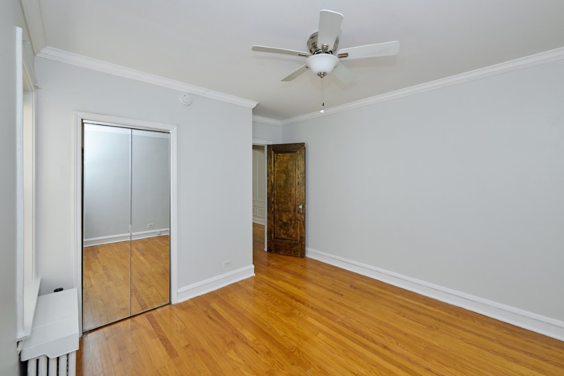 1112 Grove Street, Unit 2B Evanston, IL 60201 - Photo 16 of 21 an empty room with wooden floor and closet