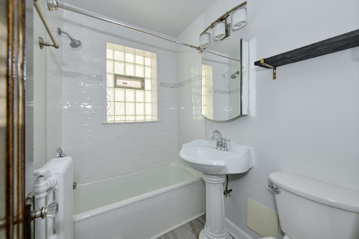 1112 Grove Street, Unit 2B Evanston, IL 60201 - Photo 17 of 21 a bathroom with a sink a toilet and a bathtub