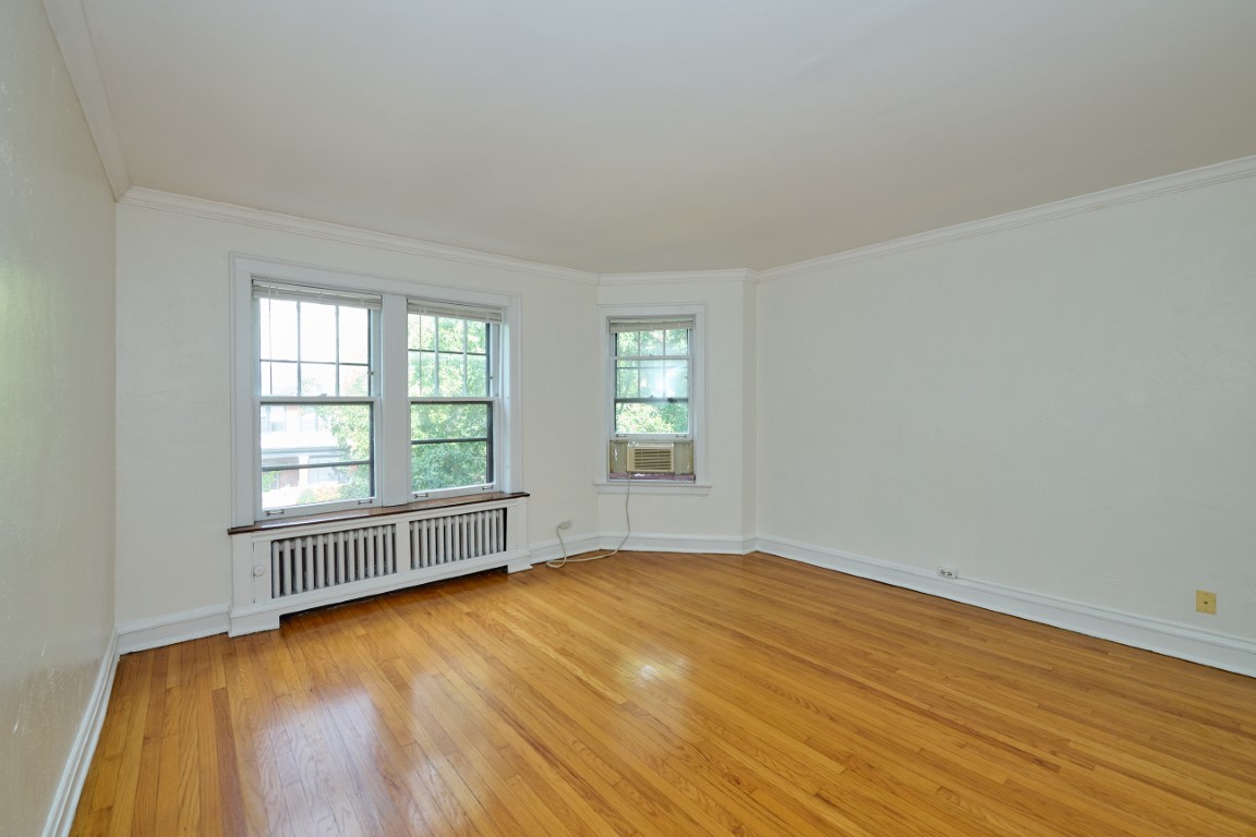 1112 Grove Street, Unit 2B Evanston, IL 60201 - Photo 5 of 21 an empty room with wooden floor and windows