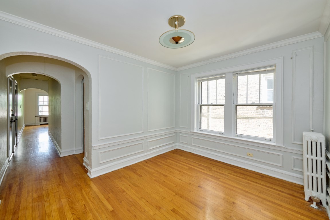 1112 Grove Street, Unit 2B Evanston, IL 60201 - Photo 9 of 21 a view of empty room with wooden floor and fan