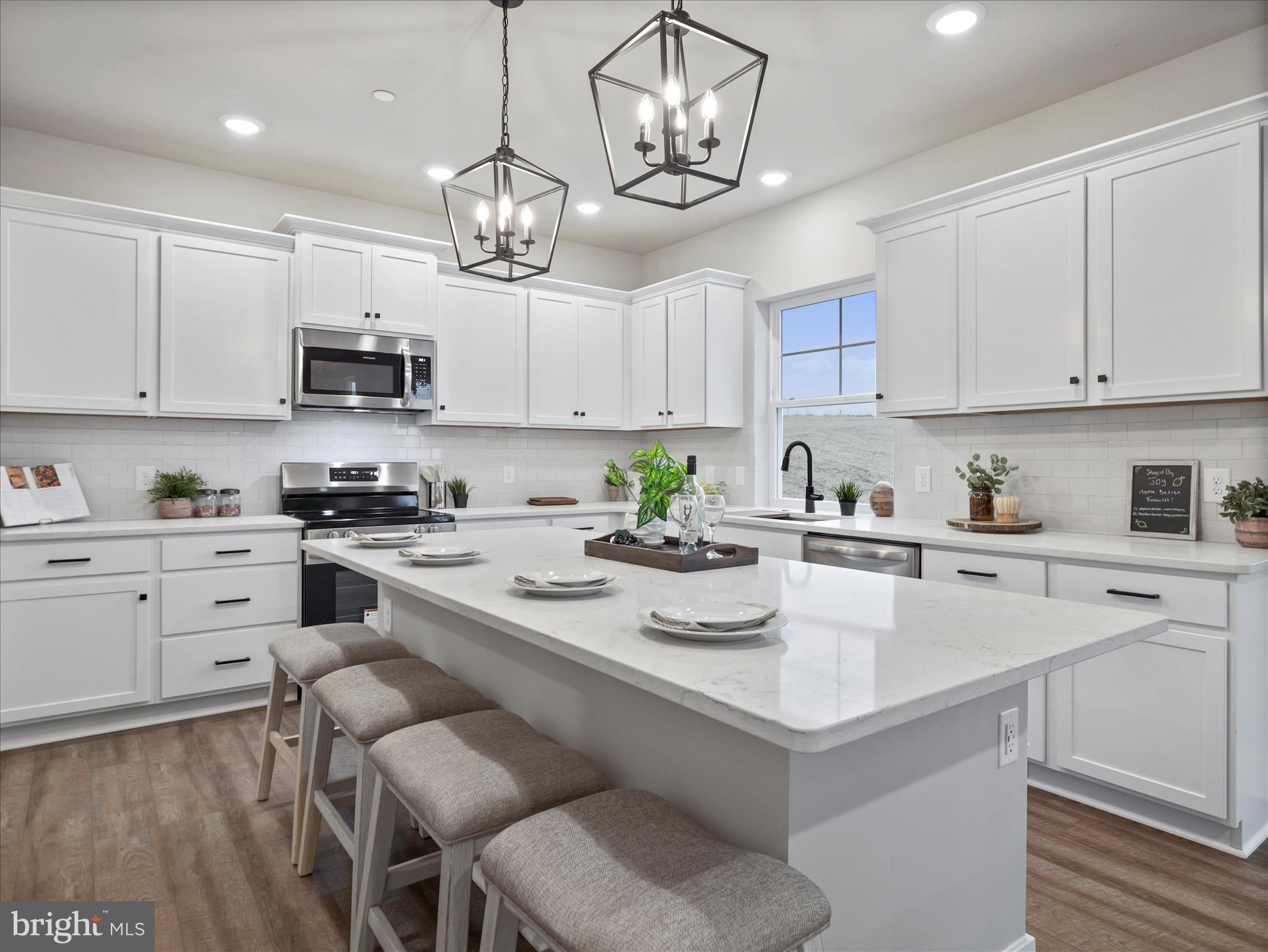 a kitchen with stainless steel appliances a stove a sink and cabinets
