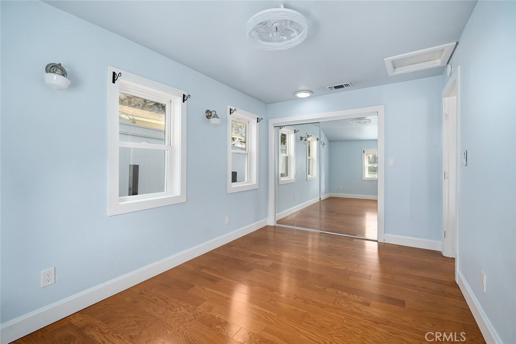 273 Pacific Avenue Paso Robles, CA 93446 - Photo 13 of 32 an empty room with wooden floor and windows