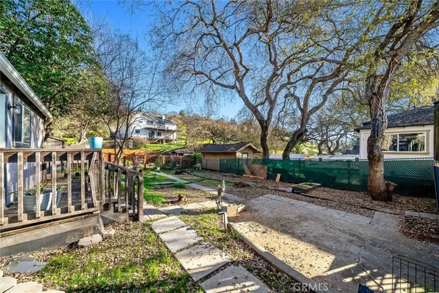a view of a house with a yard and wooden fence