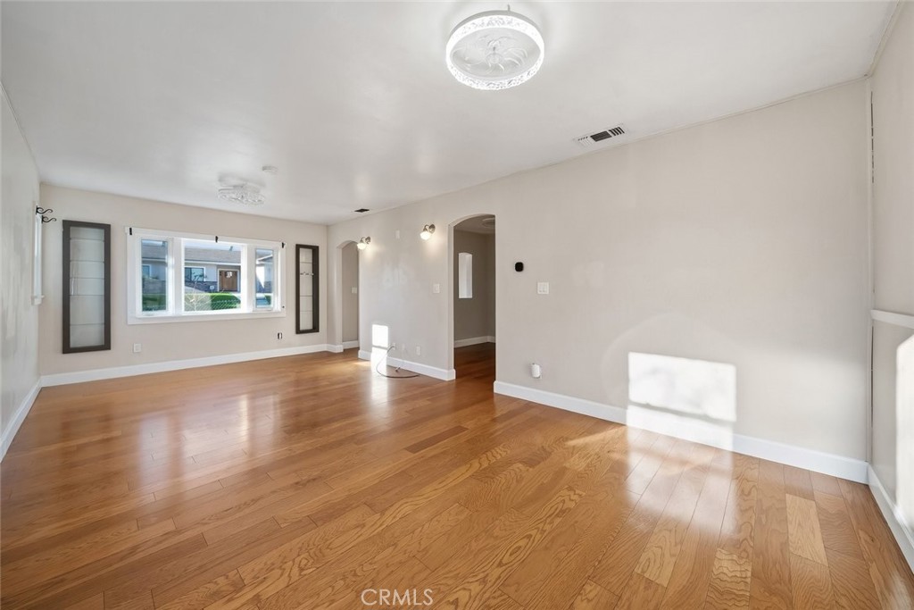 273 Pacific Avenue Paso Robles, CA 93446 - Photo 4 of 32 a view of an empty room with wooden floor and a window