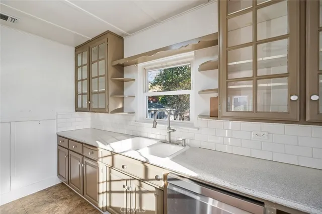 a kitchen with stainless steel appliances granite countertop a refrigerator and a stove