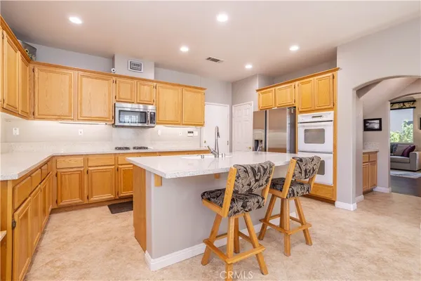 a kitchen with stainless steel appliances kitchen island granite countertop a sink and cabinets