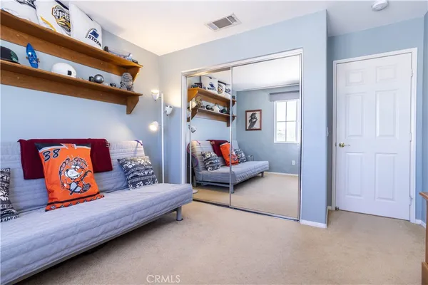 a bedroom with a bed and a desk in it