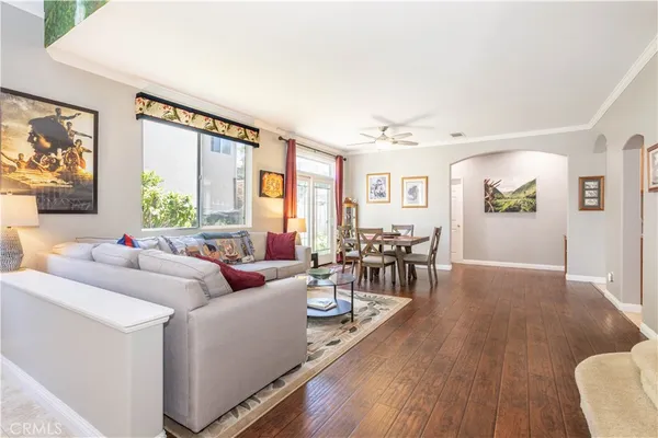 a living room with furniture and wooden floor