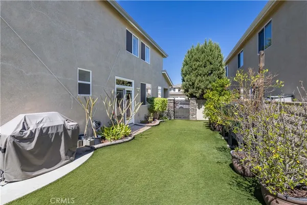 an aerial view of a house with a yard and sitting area