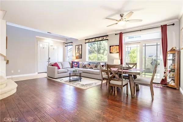 a living room with furniture and wooden floor