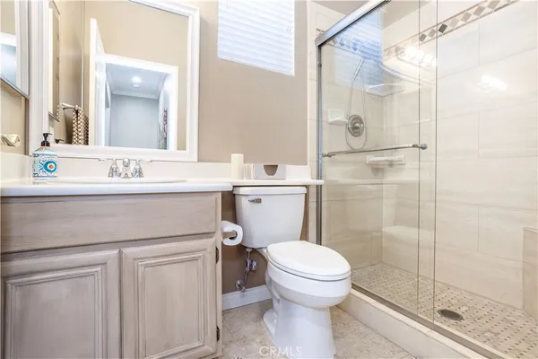 a bathroom with a sink mirror toilet and shower