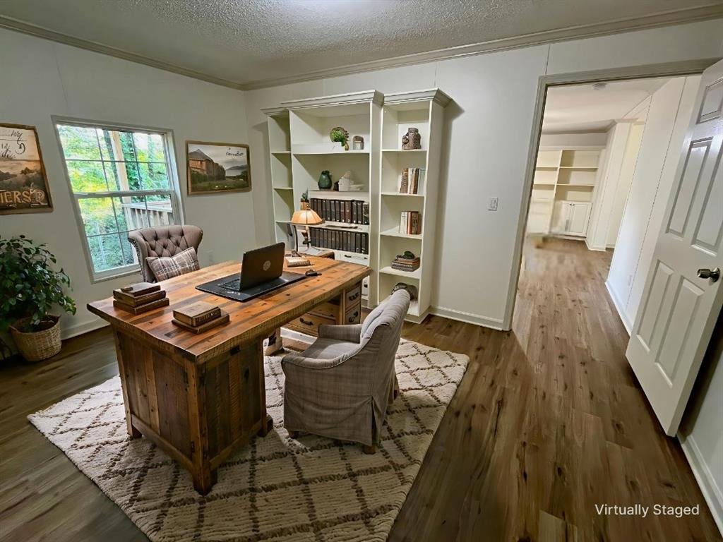 6913 Rice Road Shreveport, LA 71129 - Photo 7 of 26 a view of a workspace with furniture and wooden floor