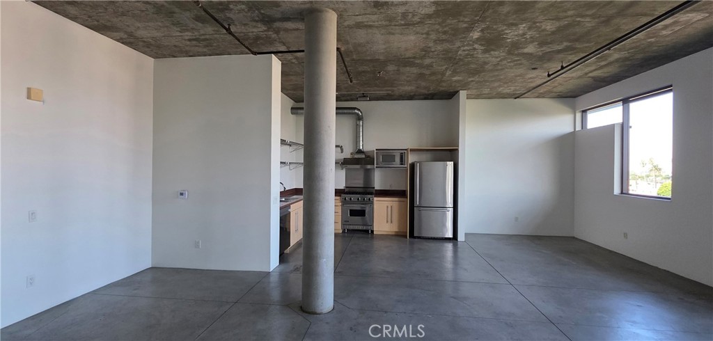 835 Locust Avenue, Unit 521 Long Beach, CA 90813 - Photo 3 of 18 a view of a kitchen with a sink and refrigerator