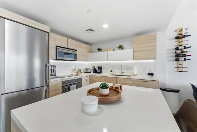 a living room with furniture a flat screen tv and a large window