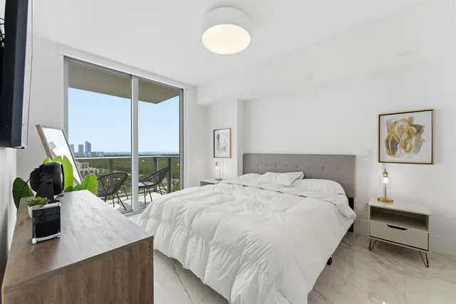 a bedroom with a bed and a flat screen tv