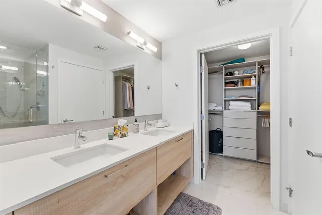 a bedroom with a balcony a bed and a chandelier