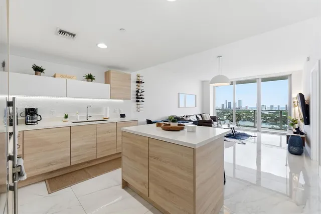 a view of a city from a balcony with outdoor seating