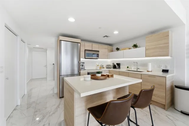 a kitchen with stainless steel appliances a stove sink and microwave