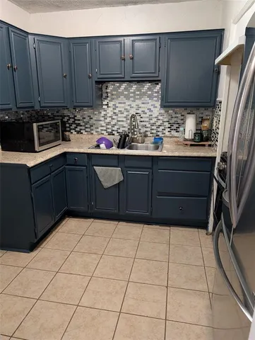 a kitchen with stainless steel appliances a sink and cabinets