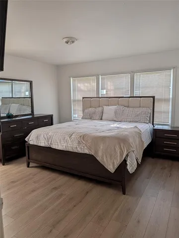 a bedroom with a bed and a night stand