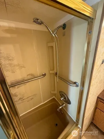 a bathroom with a granite countertop toilet sink and mirror