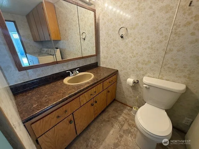 a bathroom with a toilet sink and mirror