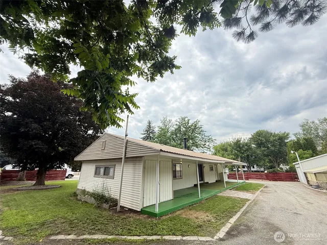 a white building with trees in front of it