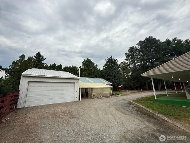 a backyard of a house with table and chairs
