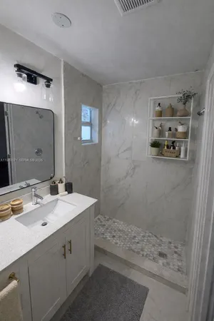 a bathroom with a sink toilet and a mirror