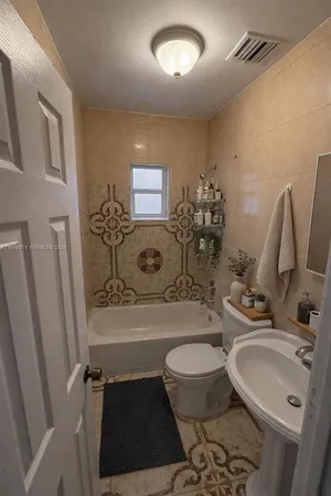 a bathroom with a sink a toilet and a tub