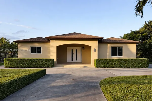 a front view of a house with a garden
