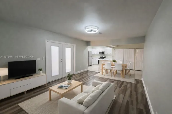 a living room with furniture and a flat screen tv